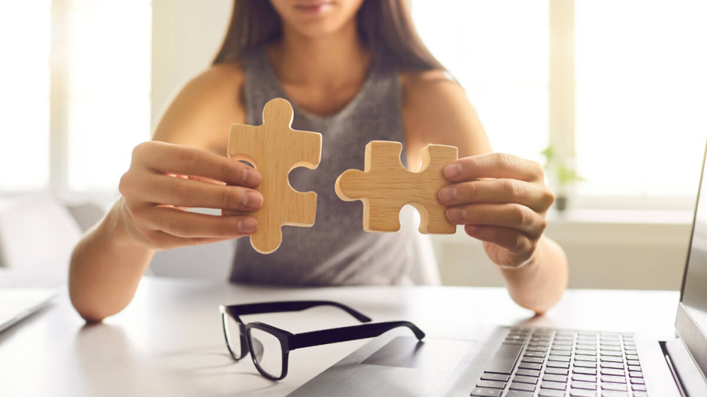 woman putting puzzle pieces together